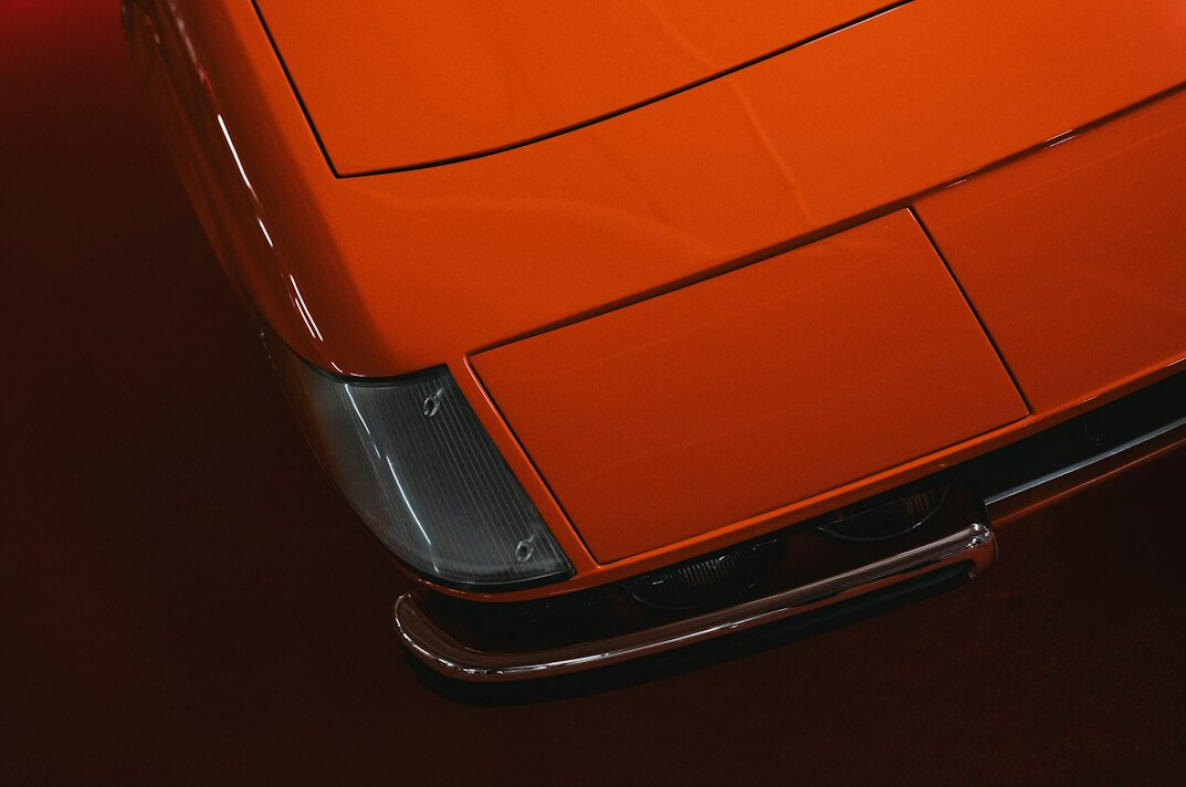 Orange hypercar on a dark background