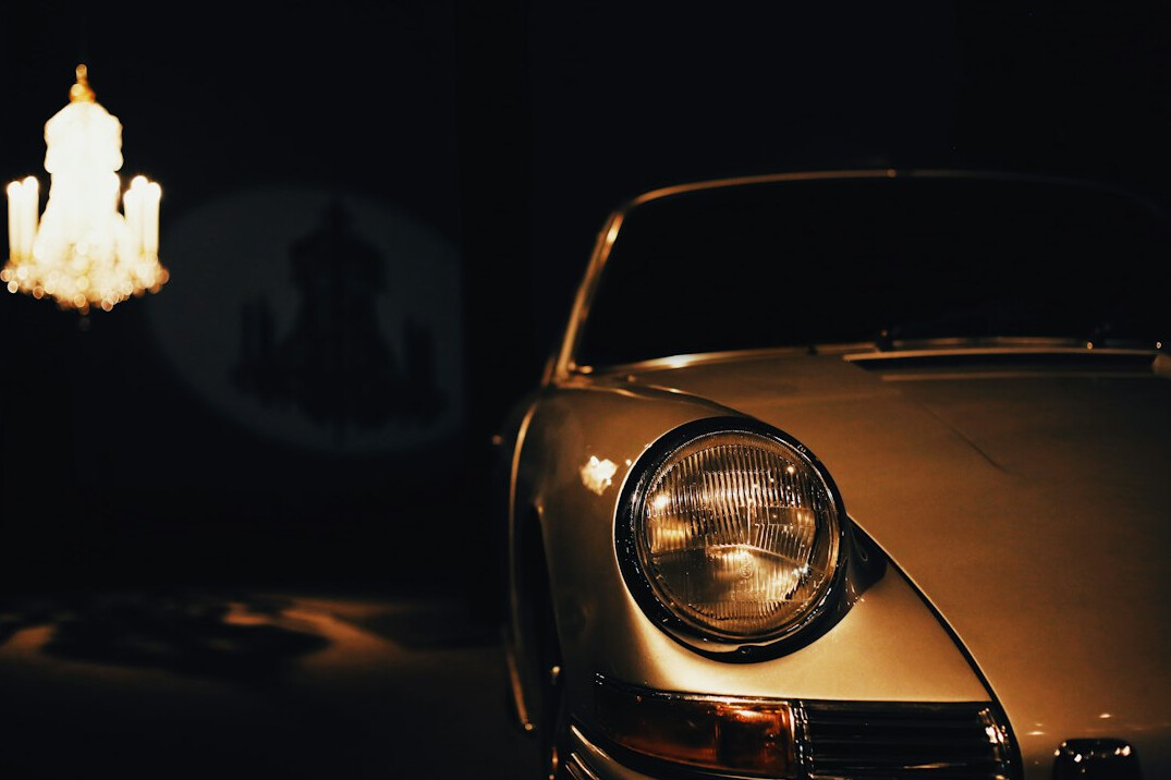 Silver sports car parked near the sea in summer